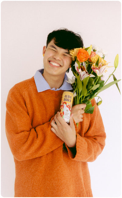 ambassador holding flowers and aura bora