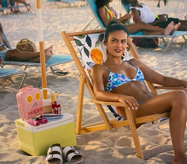 Woman drinking cactus rose Aura Bora on the beach