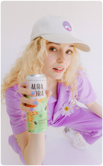 ambassador holding aura bora can